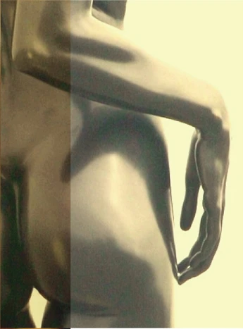 Close detail of a patinated bronze figure, with one hand resting against the torso
