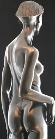 Rear three-quarter view of a reflective metal female figure against a dark background